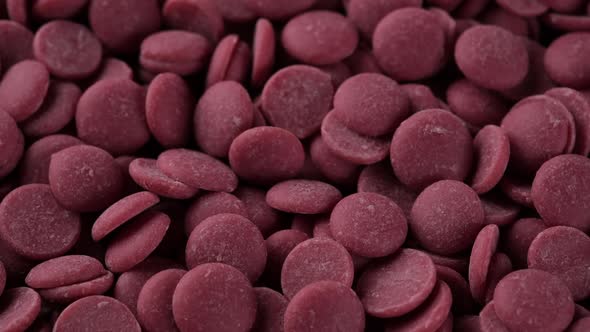 Ruby chocolate chips close up, sliding shot. Confectionery concept