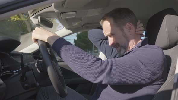 A Middleaged Handsome Caucasian Man Acts Nervous in His Car  Side Closeup