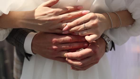 bride and groom put on rings at the wedding on their hands