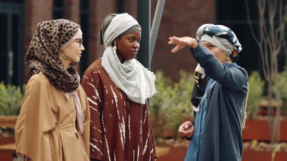 Muslim Female Friends Talking Outdoors alt