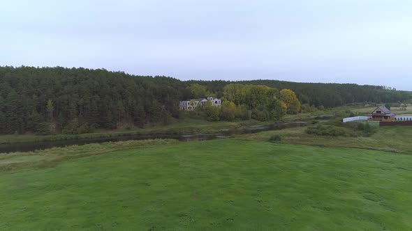 Big abandoned house in the woods on the banks of the river. 01 alt