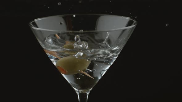 Slow motion shot of olive splashing into martini; shot on Phantom Flex 4K at 1000 fps alt