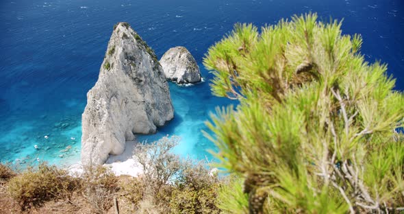 Remote Beach with Huge White Rock Formation with Blue Lagoon Tourist Pleasure Boats alt