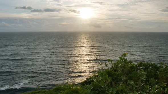 Scenic Sunset Over Indian Ocean and Green Plants on the Foreground Bali   Wide Shot alt