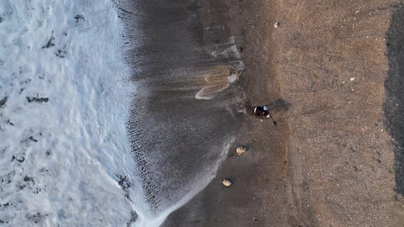 A Man Searches for Gold After a Storm Aerial View 4 K Turkey Alanya alt
