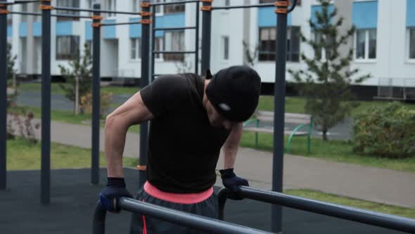 Muscular man training outdoors on sports field