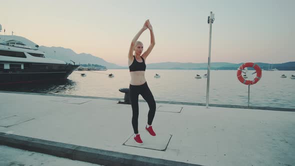 Woman Practising Sport Exercises Outdoor on the Quay