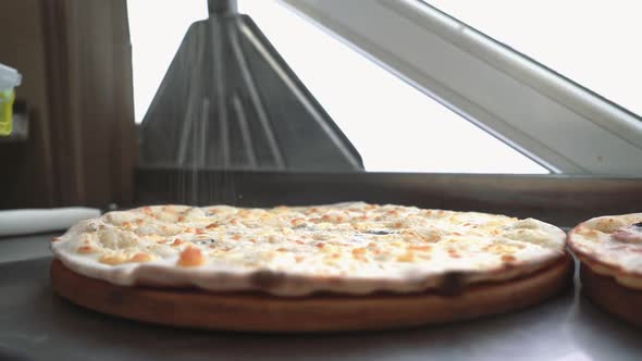 Chefs making pizza in commercial kitchen. Pizza Place. Food Preparation. Pizza Chef. alt