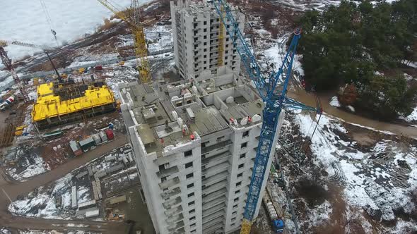 Aerial of Crane Unloading Concrete Blocks on Top of Building alt