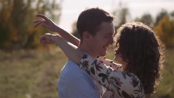 Young Couple Walking on a Meadow alt