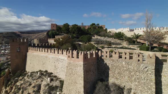 Aerial view around the walls of the Muralla de Jairán fort in Almeria, Spain - circling, drone shot alt
