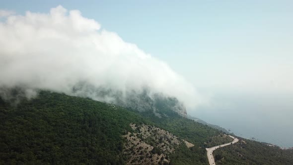 A Winding Road Through the Crimean Mountains Along the Sea alt