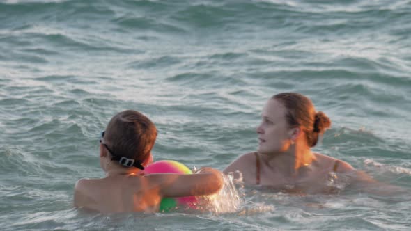 Boy Having Fun in Water with Mum alt