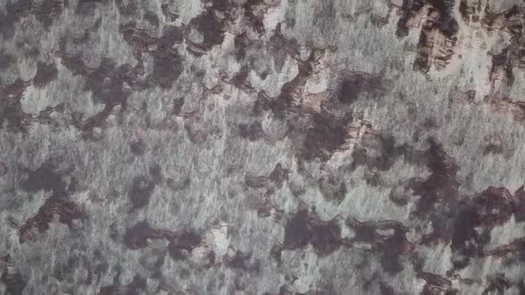 Waves shape in sand structures, local Native beach.Dramatic aerial view flight Drone top-down view alt