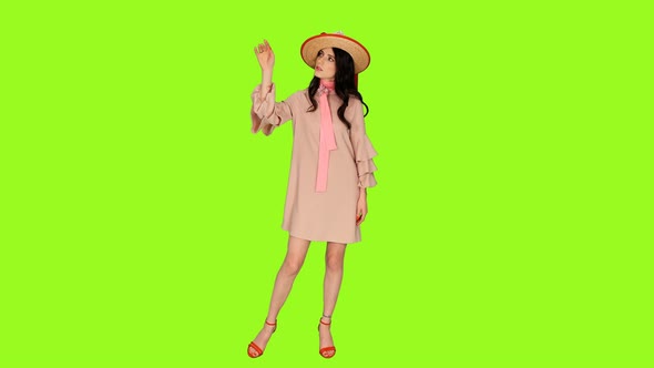 Young Beautiful Brunette Woman in Pink Dress and Straw Hat 