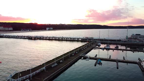 Cinematic pier in the sunset from a bird's eye view. Filming at sunset in Sopot.