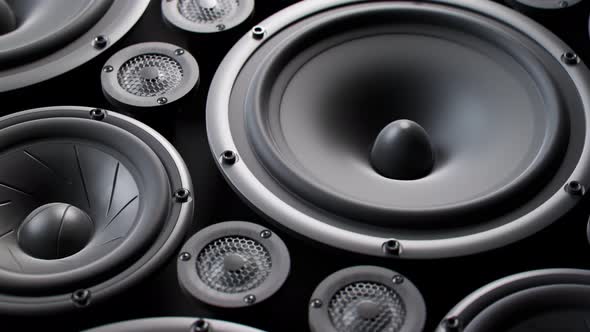 Vibrating speaker membranes stacked in endless loop. Lit by studio lights. 4k HD