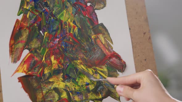 Young Woman Artist Draws a Picture with Oil Paints at Home in the Living Room alt