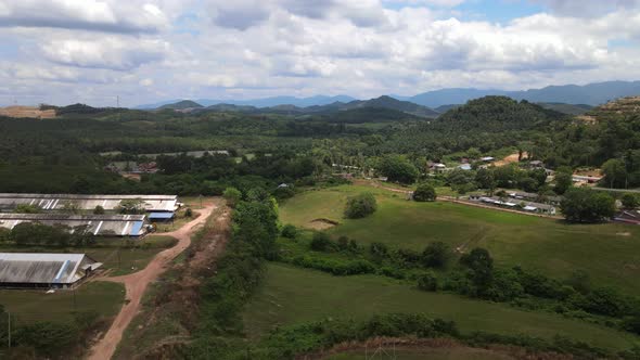 Aerial view of farm house, jungle, field, hills, mountain and clear sky in Alor Gajah, Malacca