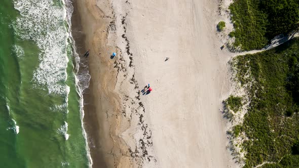 Aerial of Tourists on Vacation with Beach Umbrella in Cocoa, Florida alt