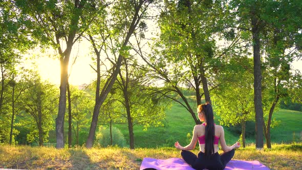 The Girl Is Sitting on the Rug and Doing Zen Meditation.