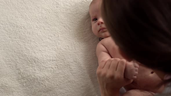 Authentic Close Up Shot Young Neo Mother Mum is Playing with Nake Newborn Child Baby on White Soft alt