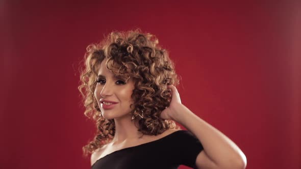 Woman with Curly Hair Dancing and Enjoying Music