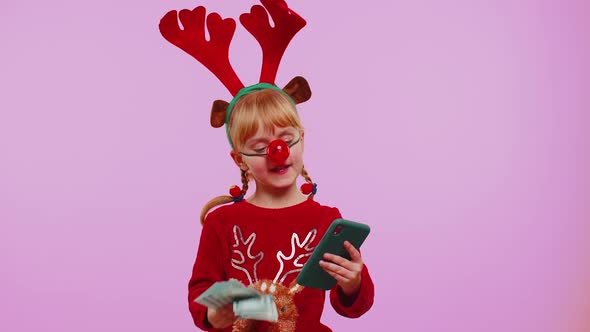 Girl in Red Christmas Deer Antlers Looking Smartphone Rejoicing Win Success Luck Receiving Money alt