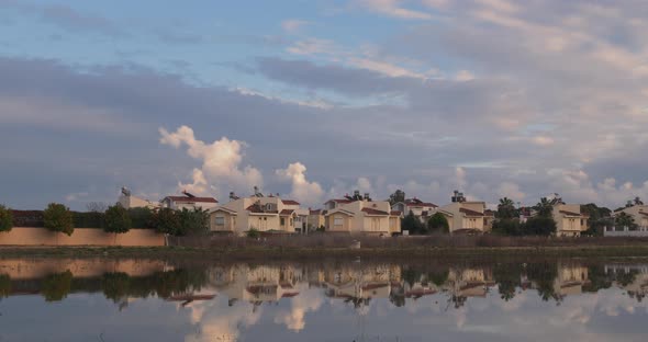 A House Next To the Lake Surrounded with Orange Trees