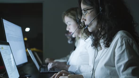 Male and Female Teleworkers in Dark Office alt