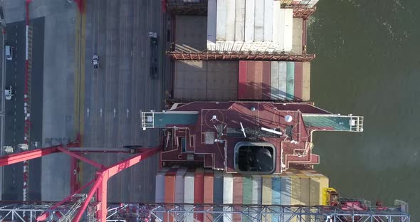 Aerial scene with drones. Container terminal of the port. Camera down with a view of ship and contai alt