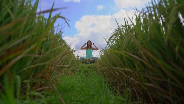 Slowmotion Steadicam Shot of a Young Woman Doing Meditation for Muladhara Chakra in a Balinese Way alt