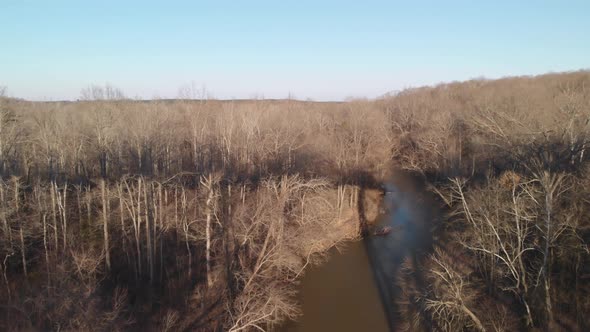 Flying backwards over the muddy Appomattox River to reveal High Bridge Trail, a reconstructed Civil alt