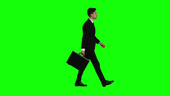 Businessman Goes To Work, with a Diplomat He Waves His Hand To Others. Green Screen alt