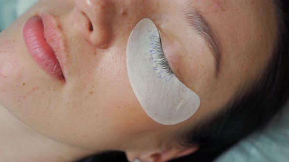 Eyelashes of a Young Beautiful Woman Closeup with a Patch of Eyes on Which the Length of Eyelashes alt