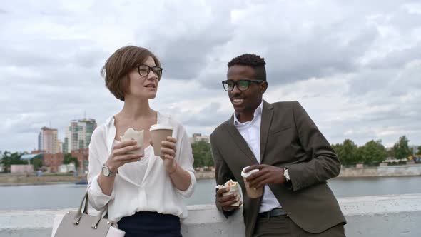 Colleagues Eating Fast Food Lunch Outdoors alt