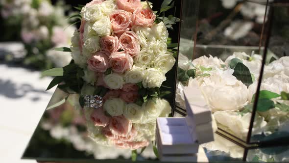 wedding gold rings on a mirror table for a wedding ceremony alt