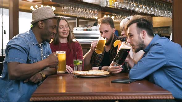 Five Young Attractive Friends Chatting in the Bar, Pub alt