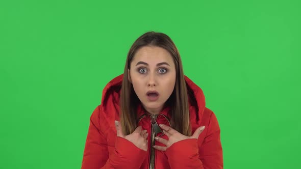 Lovely Girl in a Red Down Jacket Is Looking Camera, Pointing Herself, Say Who Me No Thanks i Do Not alt