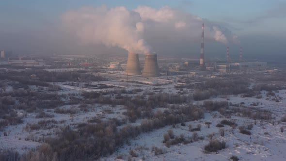 The Thermal Power Plant Works at Full Capacity in the Cold Winter During the Day Near the City