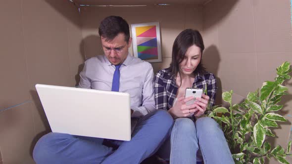 Concept Idea of a Little Roomyoung Married Couple Huddled in a Tight Box alt