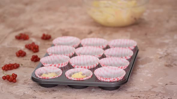 Pouring Banana Muffins Dough in Paper Molds