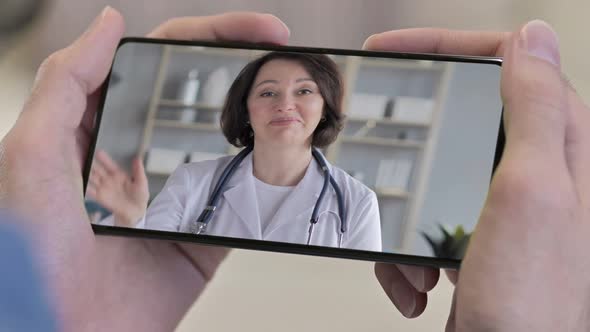 Close up of Talking Female Doctor in Smartphone Screen, Video Chat  alt