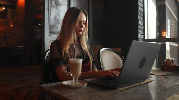Portrait of a Young Girl She Works As a Freelancer in a Cafe Drinking a Delicious Hot Cup of Coffee alt