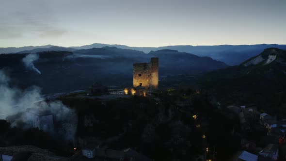Aerial View of Ancient Tower of Old Village By Night alt