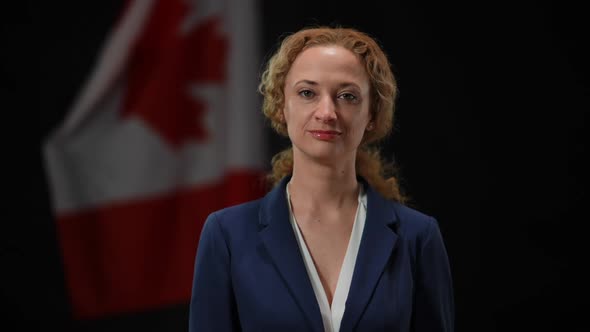 Confident Canadian Female Politician Looking at Camera Smiling with National Flag at Black alt
