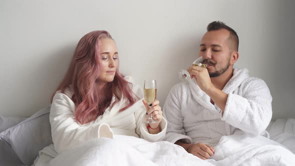 Caucasian Man and Woman Drinking Sparkling Wine alt