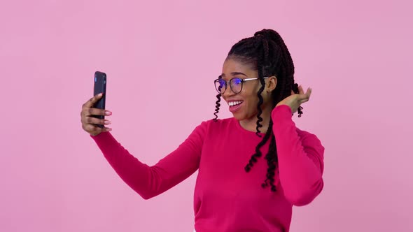 Cute Young African American Girl in Pink Clothes Communicates By Video Link alt