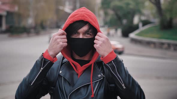 Portrait of Young Man in Protective Mask Standing Outdoors Seasonal Flu Epidemic in Country alt
