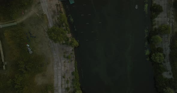 Flight Over the Canal with a Boat Station During Sunset Top View